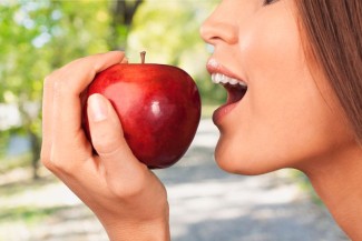 Photo: Woman Biting into an Apple