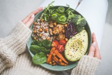 Photo: Hands holding a healthy plate of food