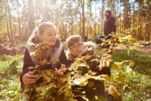 Photo: Two children engaging in nature education