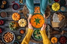 Photo: Two women holding a bowl of soup at Thanksgiving dinner